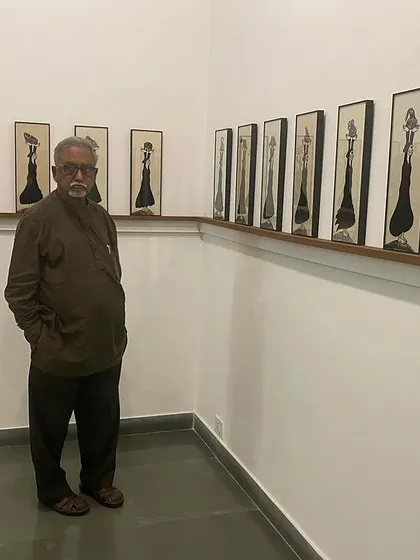Artist S.G. Vasudev posing in front of Shakuntala Kulkarni's work at her solo show.