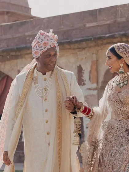 A touching moment as the bride walks with her father towards the wedding ceremony.