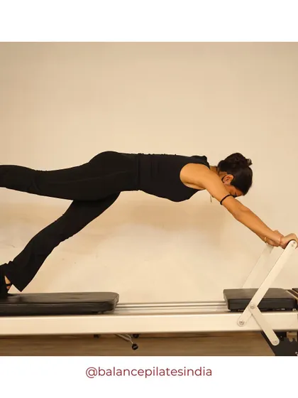 A long stretch on the reformer. This is a fantastic full-body exercise that builds strength and stability from head to toe.
