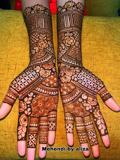 A full-hand floral design with intricate details. The roses and other flowers are shaded to give them a 3D effect.