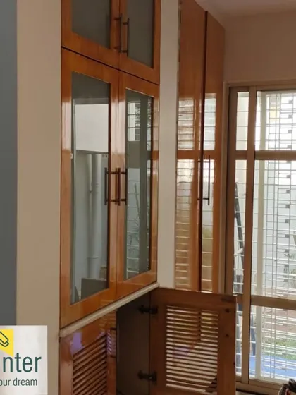 A room showing freshly painted walls next to a polished wooden crockery unit. I ensure that all your furniture and fixtures are protected during painting.