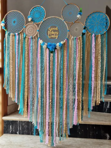 More than just decor, this "Good Vibes Only" dreamcatcher is a symbol of positivity and protection. The blend of blue, beige, and pink brings home some magic.