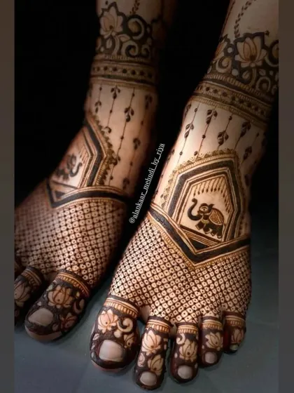 A close-up view of the delicate elephant and lotus motifs, showing the fine detail in this bridal foot design.