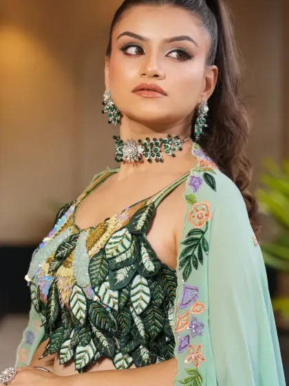 This angle shows the texture and detail of the sequined and embroidered blouse, paired with the elegant emerald choker. It’s a perfect blend of modern design and traditional elements.