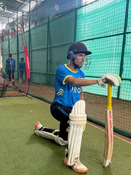 A player takes a moment between deliveries in the nets, reflecting on the previous shot and preparing for the next one.