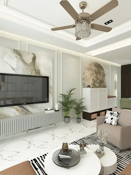 The TV wall in this living room is a masterpiece of mixed materials. We used a large marble-finish panel as the backdrop, flanked by a fluted console and minimalist decor to create a look of understated luxury.
