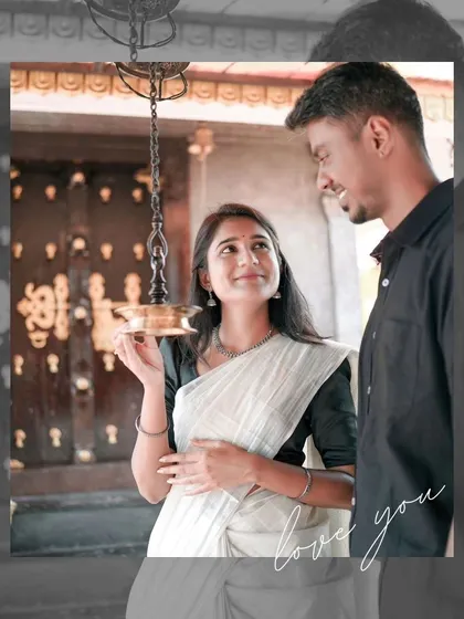 A beautiful moment inside a Kerala temple, where the bride holds a traditional lamp, her gaze connecting with the groom.