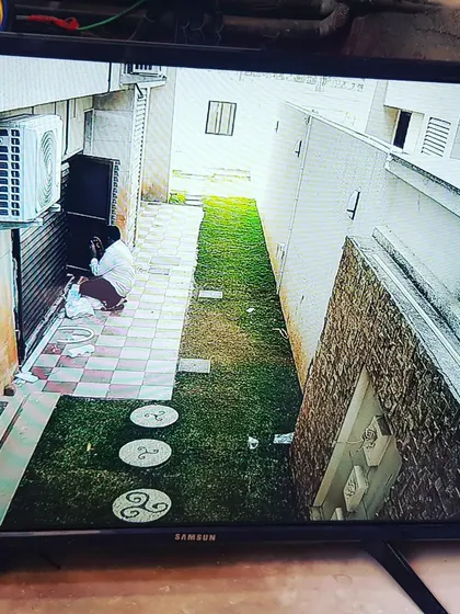 Monitoring the side of the house, including an AC unit and a narrow walkway.