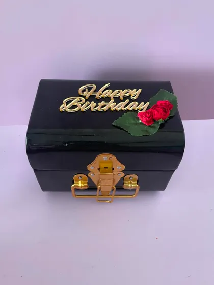 A birthday gift for him, this black trunk can be filled with a wallet, sunglasses, a belt, and other accessories.