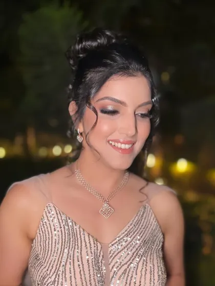 A close-up of our pretty client living in her princess era on her big day, with a glittery look and a beautiful updo.