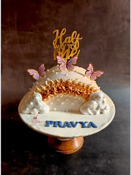 Celebrating a special milestone with a "Halfway to One" cake, adorned with delicate butterflies.