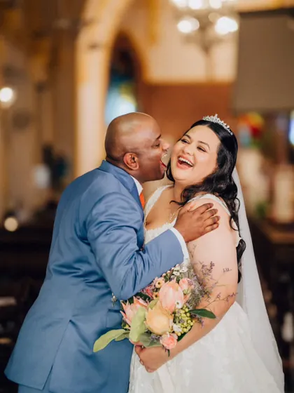 The same beautiful, candid moment from a slightly different angle, capturing the pure happiness and emotion between the bride and her loved one.