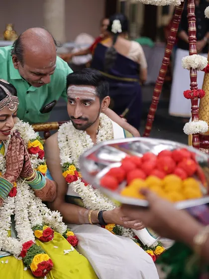 A sweet moment between the bride and groom, her beautifully stained hands folded in prayer.
