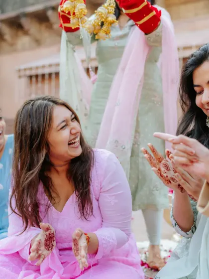 Laughter and joy as the bride's friends and family participate in the Chooda ceremony rituals.