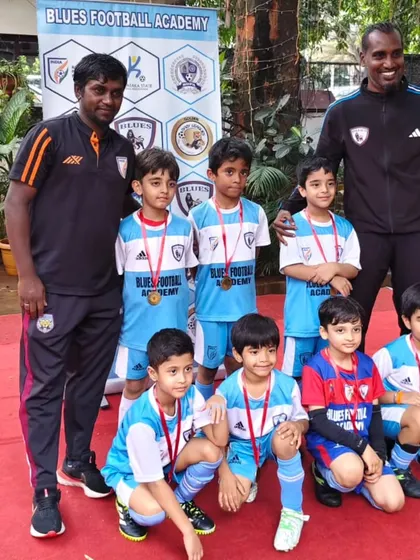 Our young players and coaches pose together after receiving their team award, a testament to their collective effort and spirit.