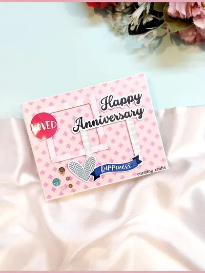 The cover of the mini anniversary scrapbook, decorated with frames and hearts.