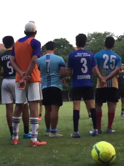 Players listening to their coach. Discipline and respect are core values we teach at the academy.