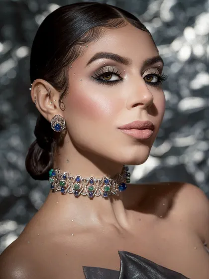 A close-up capturing the shimmering details on the skin and the precise makeup work, creating a look of pure, modern luxury.
