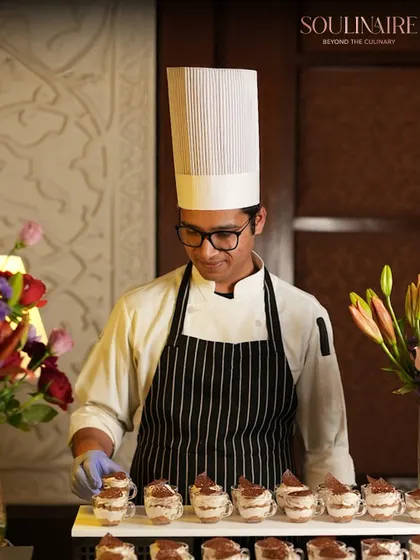 A chef carefully preparing tiramisu cups. The appreciation from our guests for our culinary creations and service inspires us to continue our work.