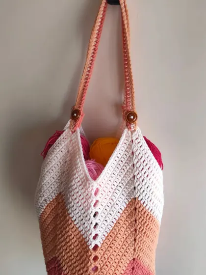 A hanging shot of the Chevron Tulip Bag, emphasizing its shape and the sturdy construction of its handles. It's a practical and stylish piece for anyone who loves handmade accessories.
