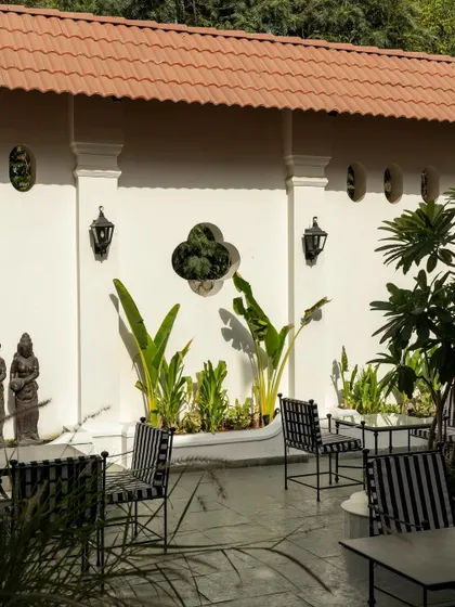 Views of the courtyard at Elgin Cafe, a space designed for pause and reflection. I used white lime-washed walls, lush tropical plants, and classic lantern-style lighting to create an intimate, serene outdoor dining experience.