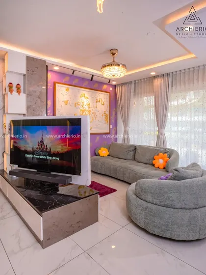 Another angle of the vibrant living room, showing how the custom rotatable TV unit connects the living and dining areas. The plush, modern sofas offer ultimate comfort.