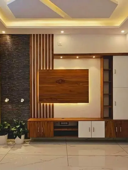 I love mixing materials for a richer look. This TV unit combines a textured stone panel, fluted wood, and clean white cabinets for a design that is full of depth and character.