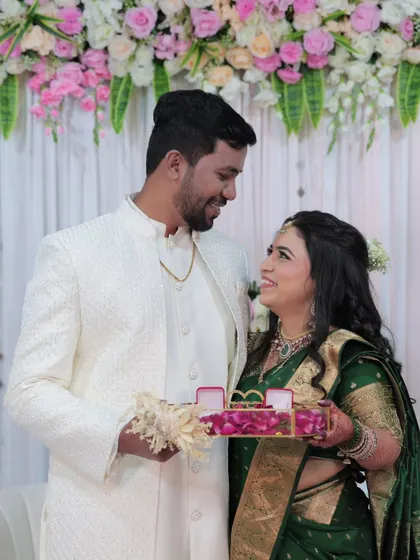 A sweet moment between the couple during the ring ceremony. Her makeup remains flawless, capturing her joyful expression.