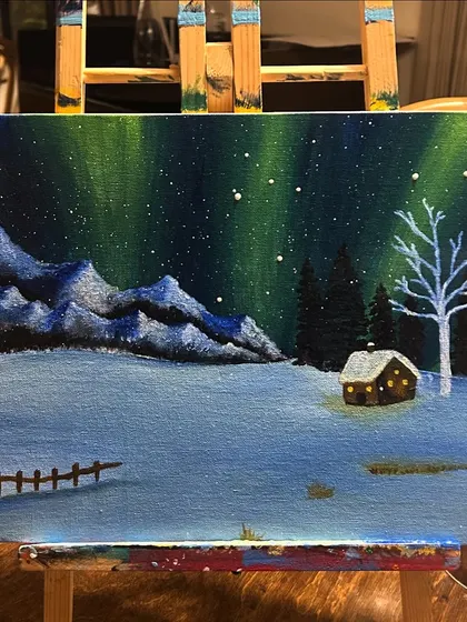 You don't need to travel to see the northern lights. This beautiful aurora borealis scene was painted by a participant, capturing the magic of a winter night on canvas.