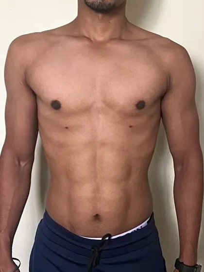The "after" physique. A clear view of the defined abs and leaner frame, the result of a dedicated fat loss program.