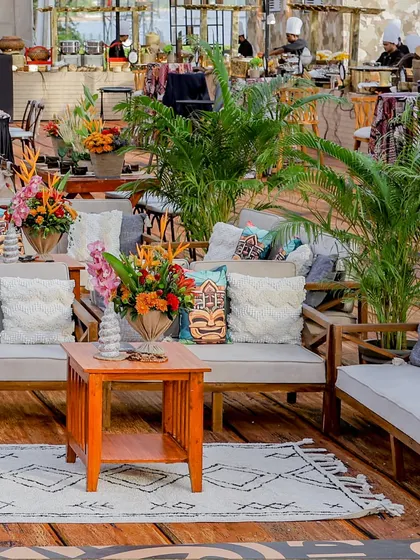 Another view of the lounge area, showing the abundance of potted palm trees that help to create a lush, jungle-like atmosphere.