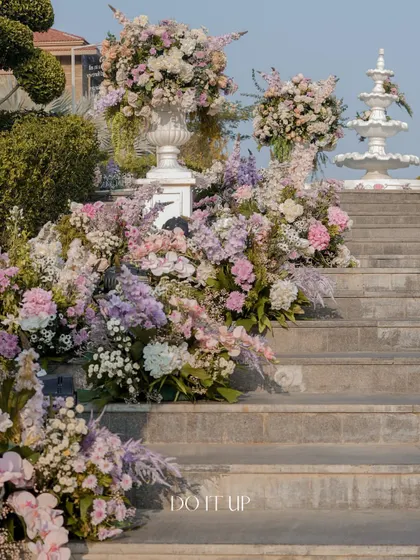 The stairs leading to the wedding venue, adorned with large urns overflowing with pastel flowers. This created a grand and welcoming entrance for all the guests.