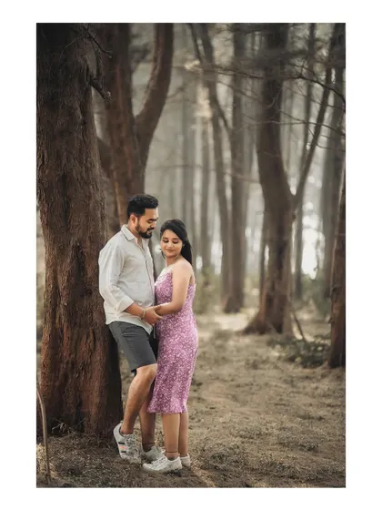 A quiet, romantic pose against a tree in a misty forest. The moody atmosphere is perfect for intimate couple shots.