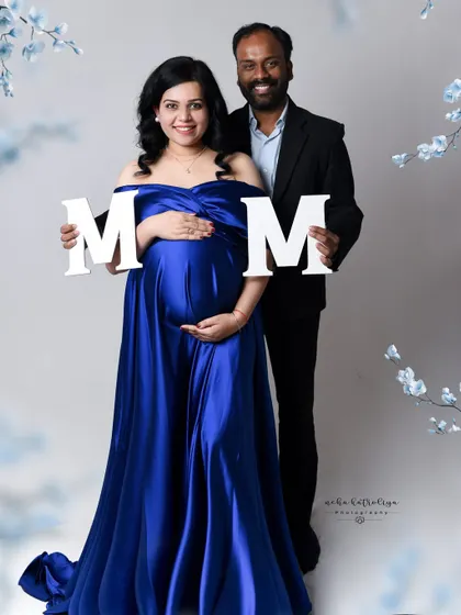 Using simple props like these letters can add a fun, personalized element to your maternity photos. It's a great way to hint at a name or simply celebrate the moment.