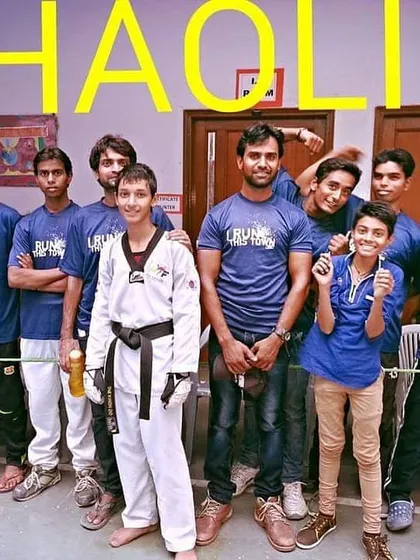Posing with my team of young fighters. Each student, whether in a dobok or team shirt, is part of the Shaolin Taekwondo Academy family.
