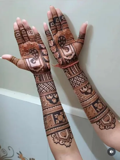 A reverse view of a bridal design, showing how the intricate patterns continue on the back of the hands and arms.