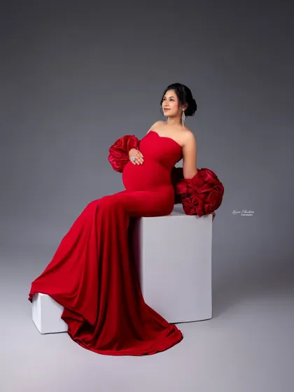 Bold and beautiful in red. This off-the-shoulder bodycon gown with dramatic floral sleeves is a statement piece from my client wardrobe, perfect for showcasing your confidence and pregnancy glow.