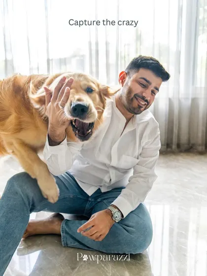 Capturing the crazy! A golden retriever playfully paws at his dad's face, showing the fun and unpredictable nature of shooting with pets.