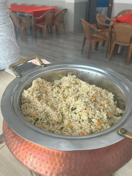 A steaming pot of vegetable fried rice, ready to be served. I ensure every dish, from the main course to the sides, is prepared fresh and kept at the perfect temperature throughout your event.