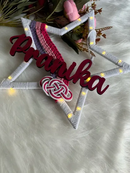 An angled view of the lit-up 'Pranika' star hanging, showing how it can brighten up a space.
