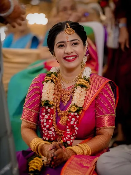 A bright and happy portrait of the bride, her smile and beautiful traditional attire lighting up the frame.