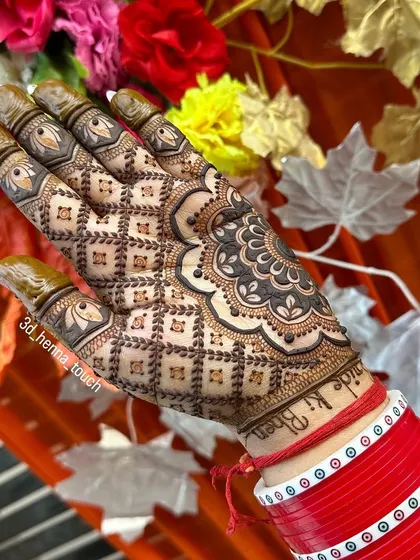 A close-up of a beautiful 'jaal' or net pattern on the back of a hand, with a bold mandala at the wrist. The color of the stain is rich and dark.