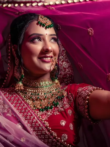 A happy bride looking up, framed by her colorful dupatta. A shot full of hope and joy.