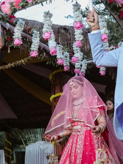 A closer look at the bride's entry. We focus on the bride's expression and the beautiful floral canopy above her.