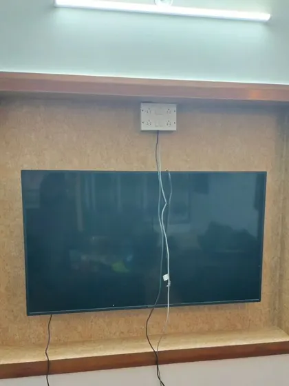 A cork-textured wallpaper used as a background within a TV frame.