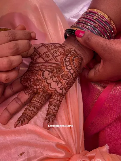 Every stroke matters. This image captures the careful application of a complex pattern on the palm, showcasing the fine lines and shading techniques that I teach in my classes.