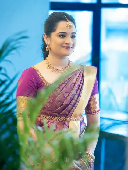 A candid shot capturing her natural elegance. The makeup is subtle, designed to look fresh and effortless for her engagement ceremony.