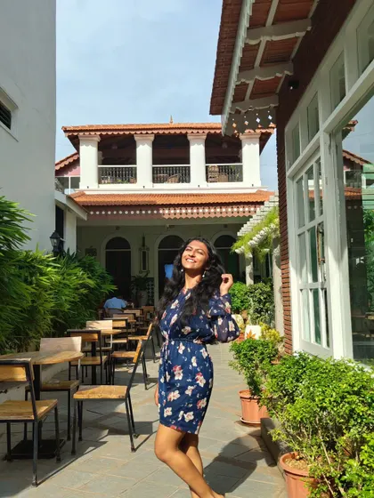 A happy, sun-drenched moment at a beautiful outdoor cafe. This candid lifestyle photo shows a bright and cheerful personality, great for commercial work.
