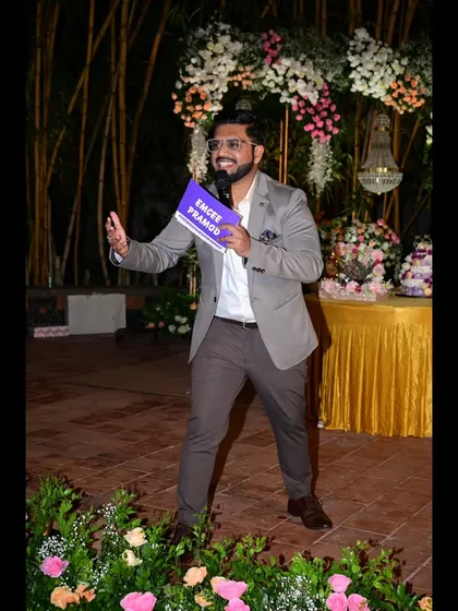 Holding my 'Emcee Pramod' placard, a key part of my branding.
