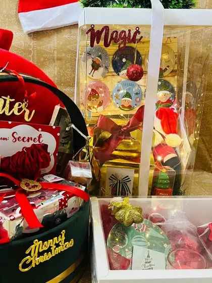 Another view of the premium Christmas hamper collection, showing the 'Magic' themed transparent gift bag and velvet box.